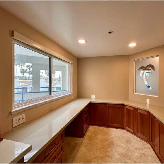 a room with a window and a picture on the wall.