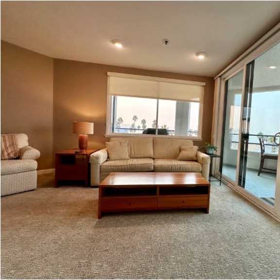 a living room with a couch, a table, and a chair.