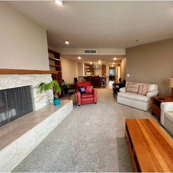 a living room with a fireplace, couches, and a coffee table.