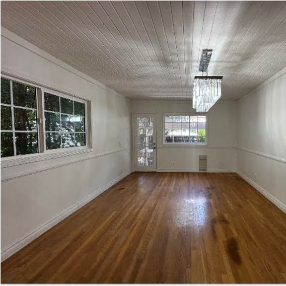 a room with wooden floors and white walls.
