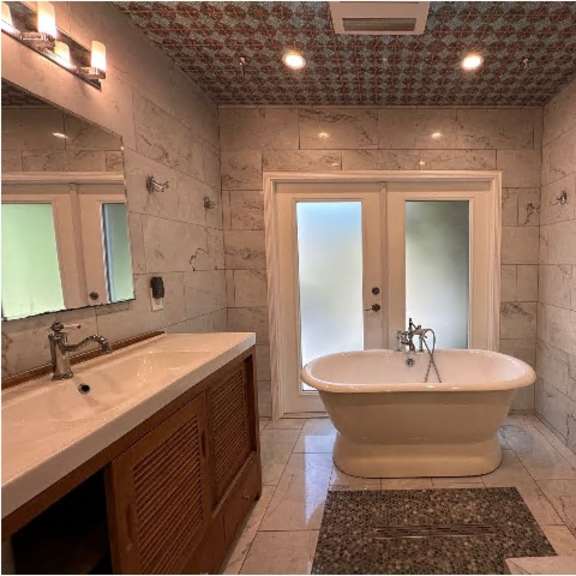 a bathroom with a white tub and a sink.