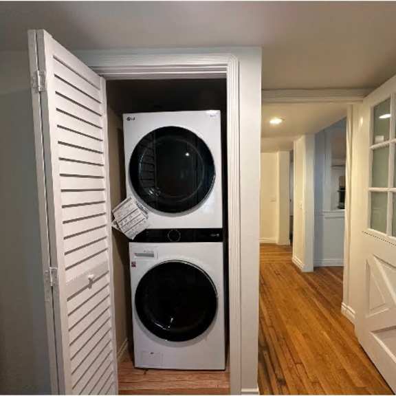 a white washer and dryer are stacked on top of each other in a small closet.