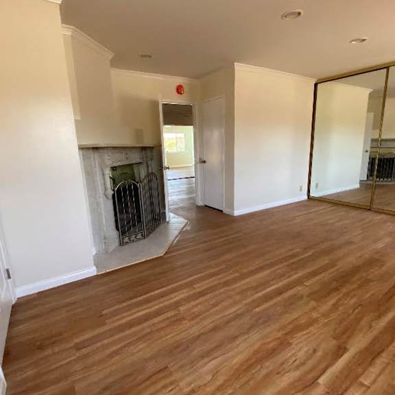 a room with wooden floors and a fireplace.