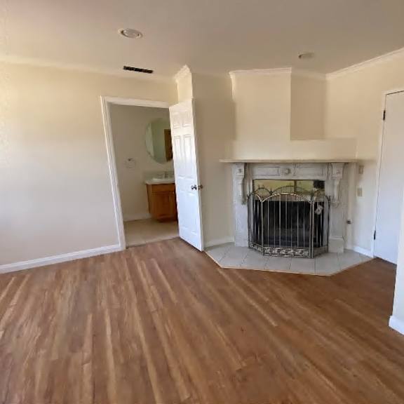 a room with a wood floor and a fireplace.