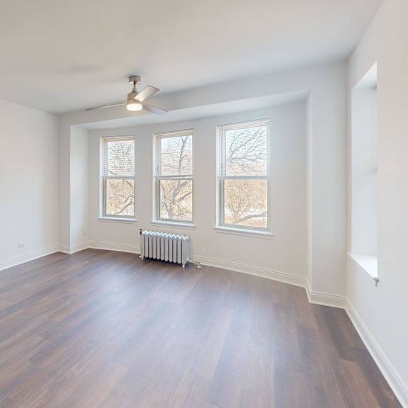a room with wooden floors and white walls.
