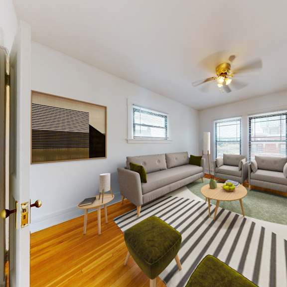 a living room with a striped rug and a grey couch.