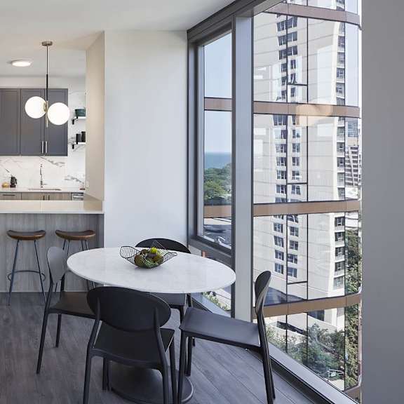 a modern kitchen with a dining table and chairs.