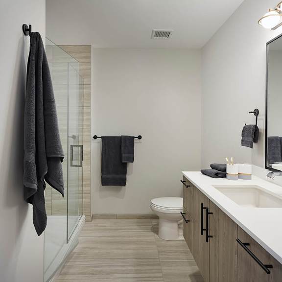 a bathroom with a white sink and a white toilet.