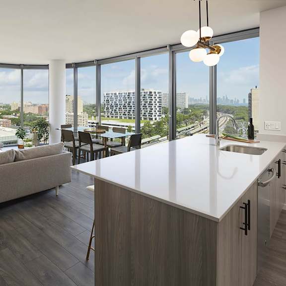 a modern kitchen and living room with a view of the city.