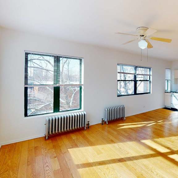 a room with wooden floors and white walls.