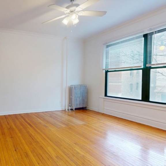 a room with a wooden floor and a ceiling fan.