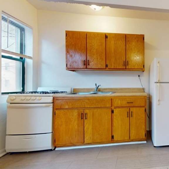 a kitchen with wooden cabinets and a white stove.