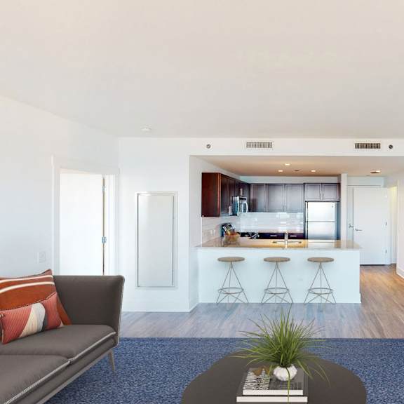 a living room with a couch, a coffee table, and a bar area.