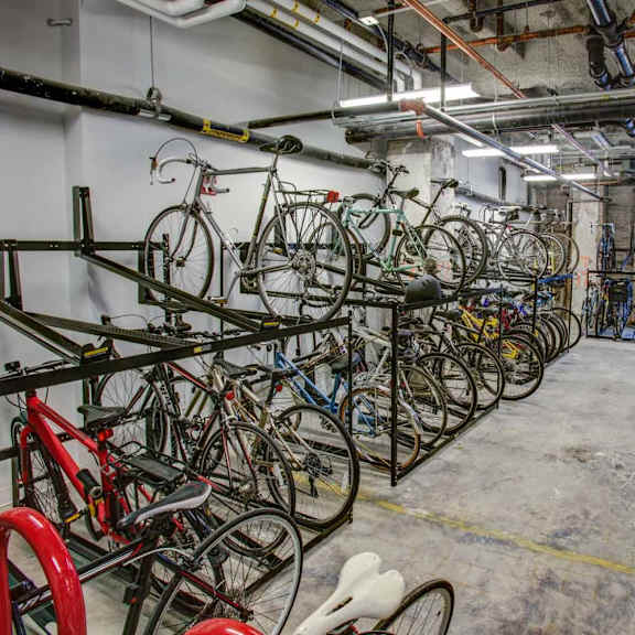 a bike rack full of bicycles in a room.