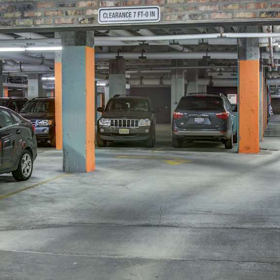 a parking garage with cars parked and a sign that says