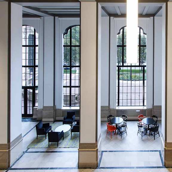 a large room with columns and tables.