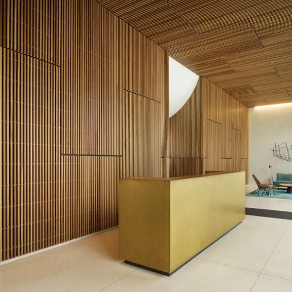 a room with a wooden wall and a yellow box on the floor.