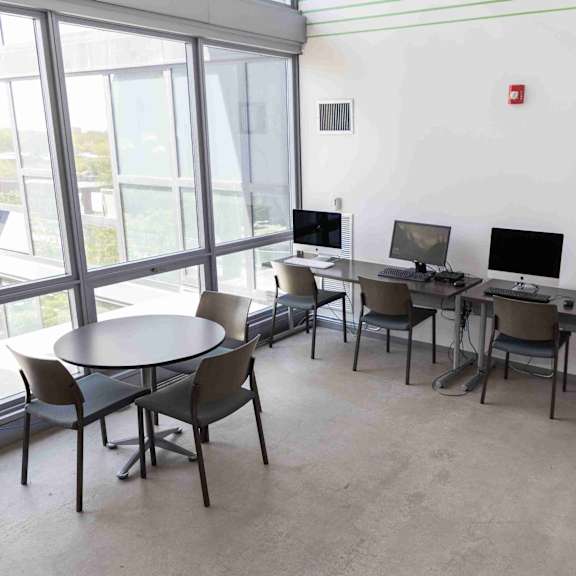 a room with a table and chairs and a sign that says