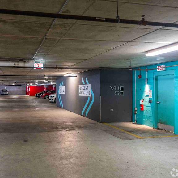 a parking garage with a blue door and a sign that says
