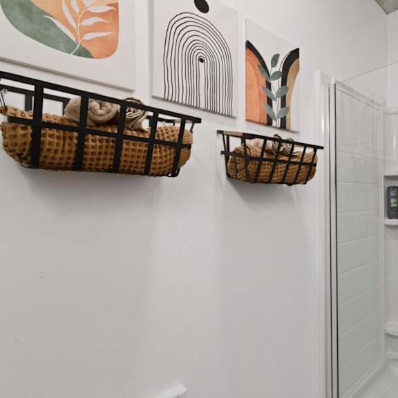 a bathroom with a white wall and a glass door.