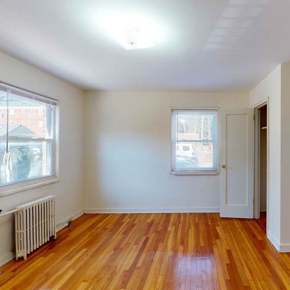 a room with wooden floors and white walls.