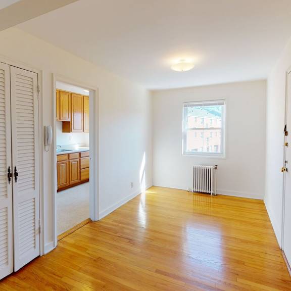 a room with wooden floors and white walls.