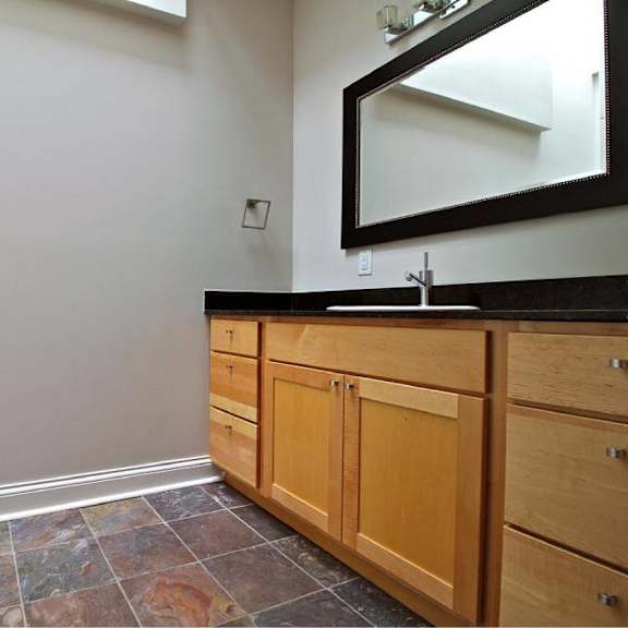 a bathroom with a vanity and a mirror.