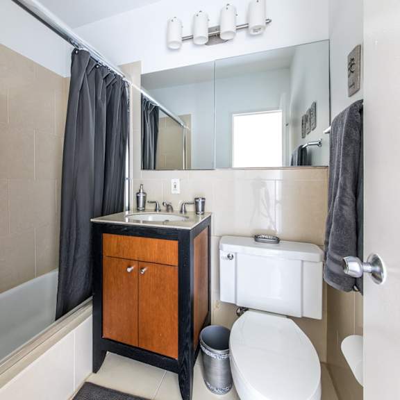 a bathroom with a white toilet, a sink, and a bathtub.