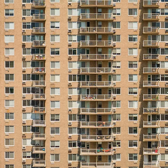 a tall apartment building with balconies and windows.