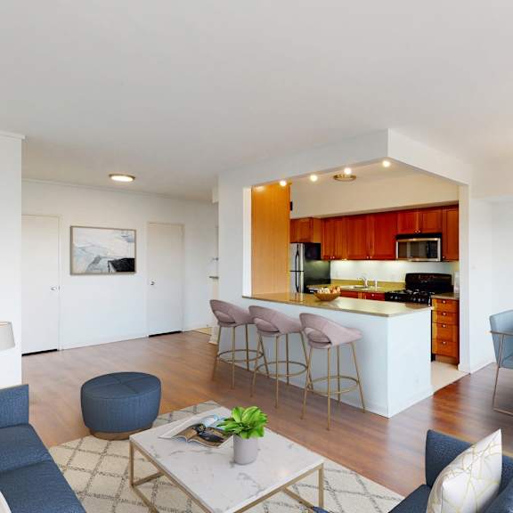 a modern living room with a dining area and kitchen in the background.