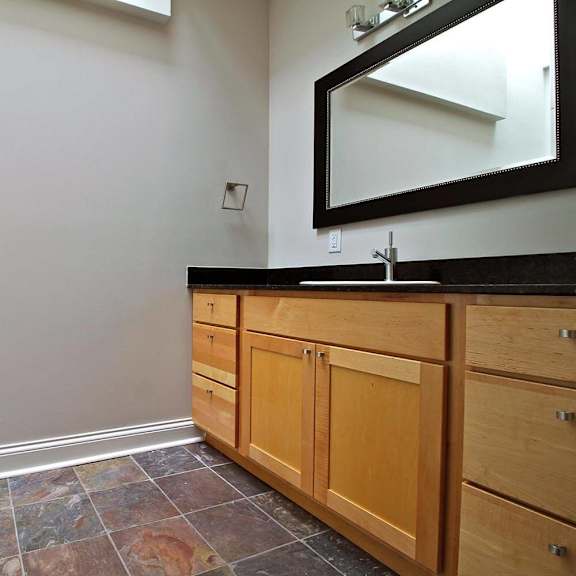 a bathroom with a vanity and a mirror.