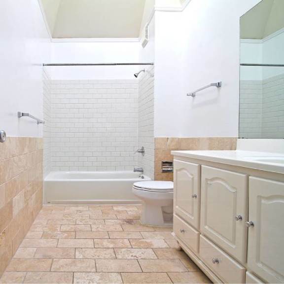a white toilet is in a bathroom with a walk-in shower.