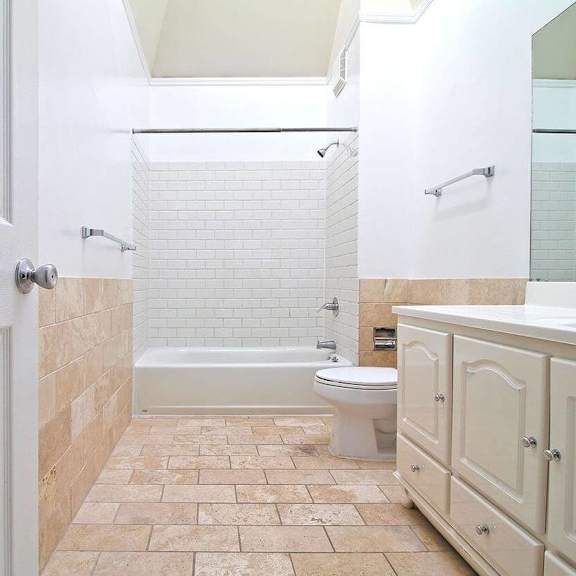 a white toilet is in a bathroom with a walk-in shower.
