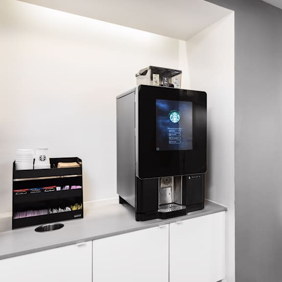 a modern kitchen with a black coffee machine on the counter.
