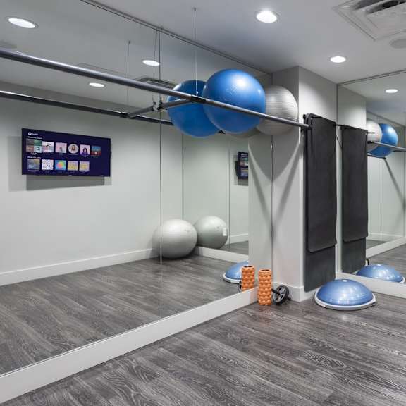 a room with exercise balls and a mirror on the wall.