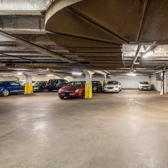 a parking garage with several cars parked.