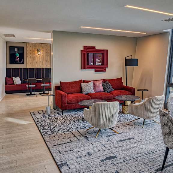 a living room with a red couch and a round table.