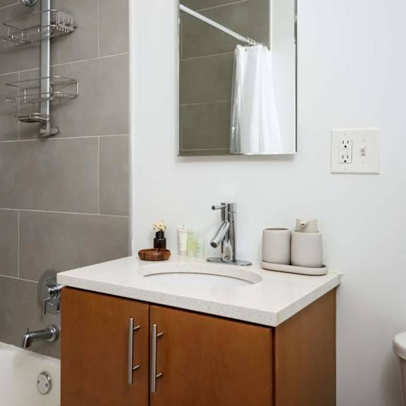 a bathroom with a white sink and a white tub.