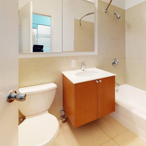 a white toilet sits next to a sink in a bathroom.
