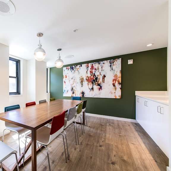 a dining room with a table and chairs.