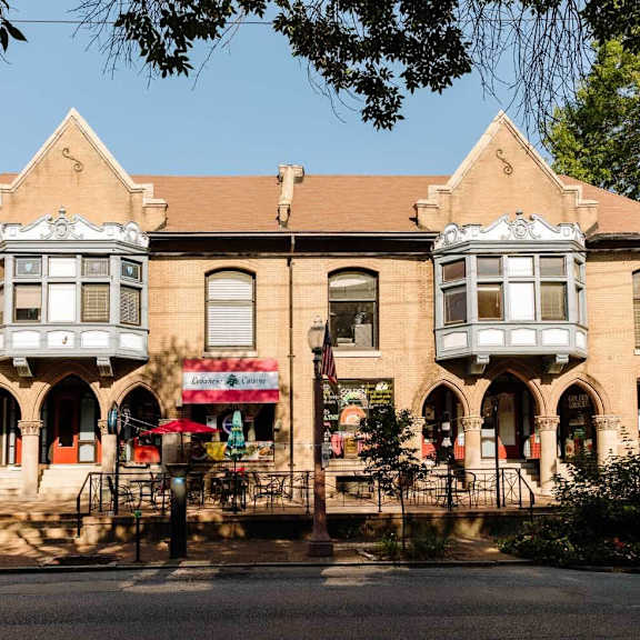a building with a red and white striped awning is in the foreground.