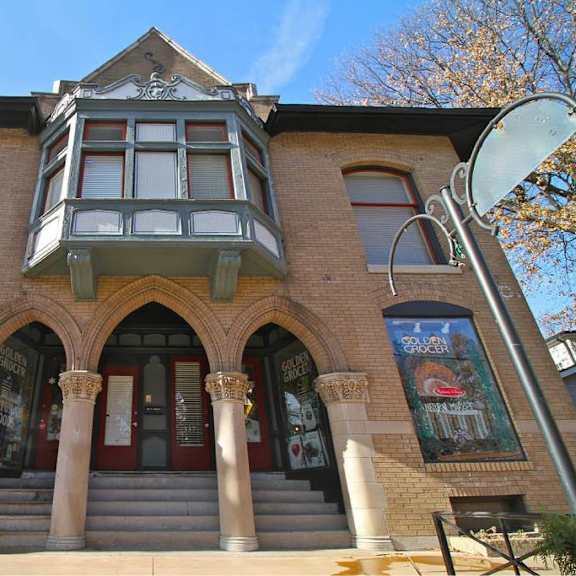 a building with a red door and a balcony.