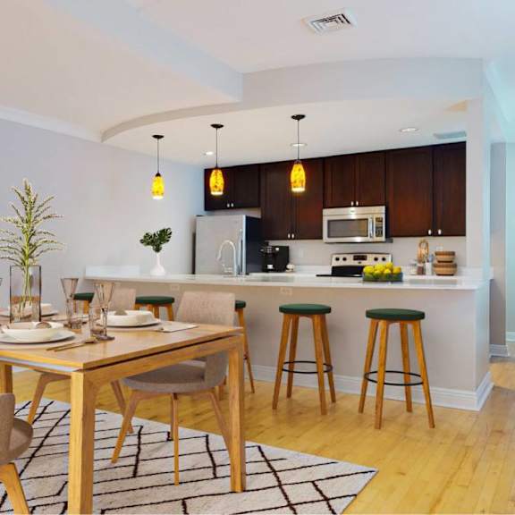 a modern kitchen with a dining table set for two.