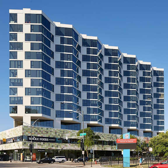 a tall building with many windows is in the background.