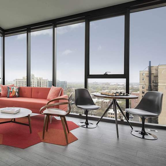 a living room with a red couch and a coffee table.