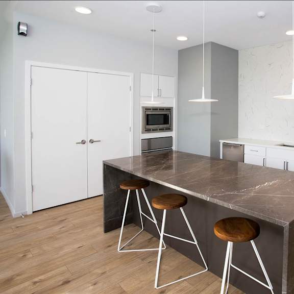a kitchen with a large island and stools.