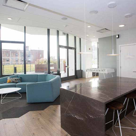 a modern kitchen with a large island and bar stools.