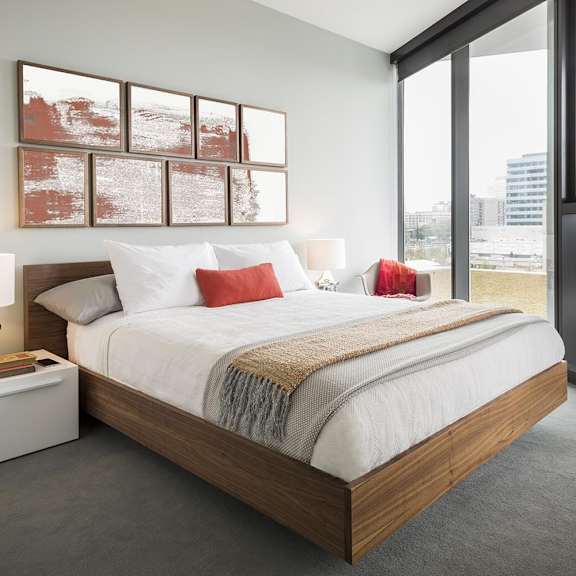 a bedroom with a large bed and a painting on the wall.