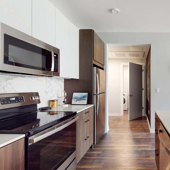 a modern kitchen with a bowl of fruit on the counter.
