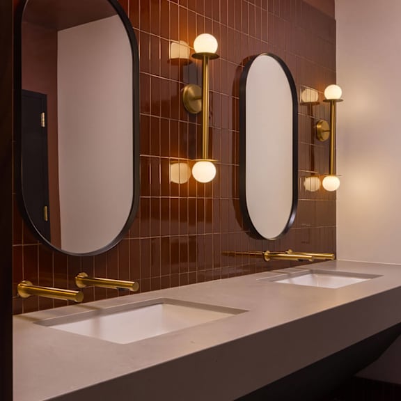 a bathroom with two sinks and two mirrors.